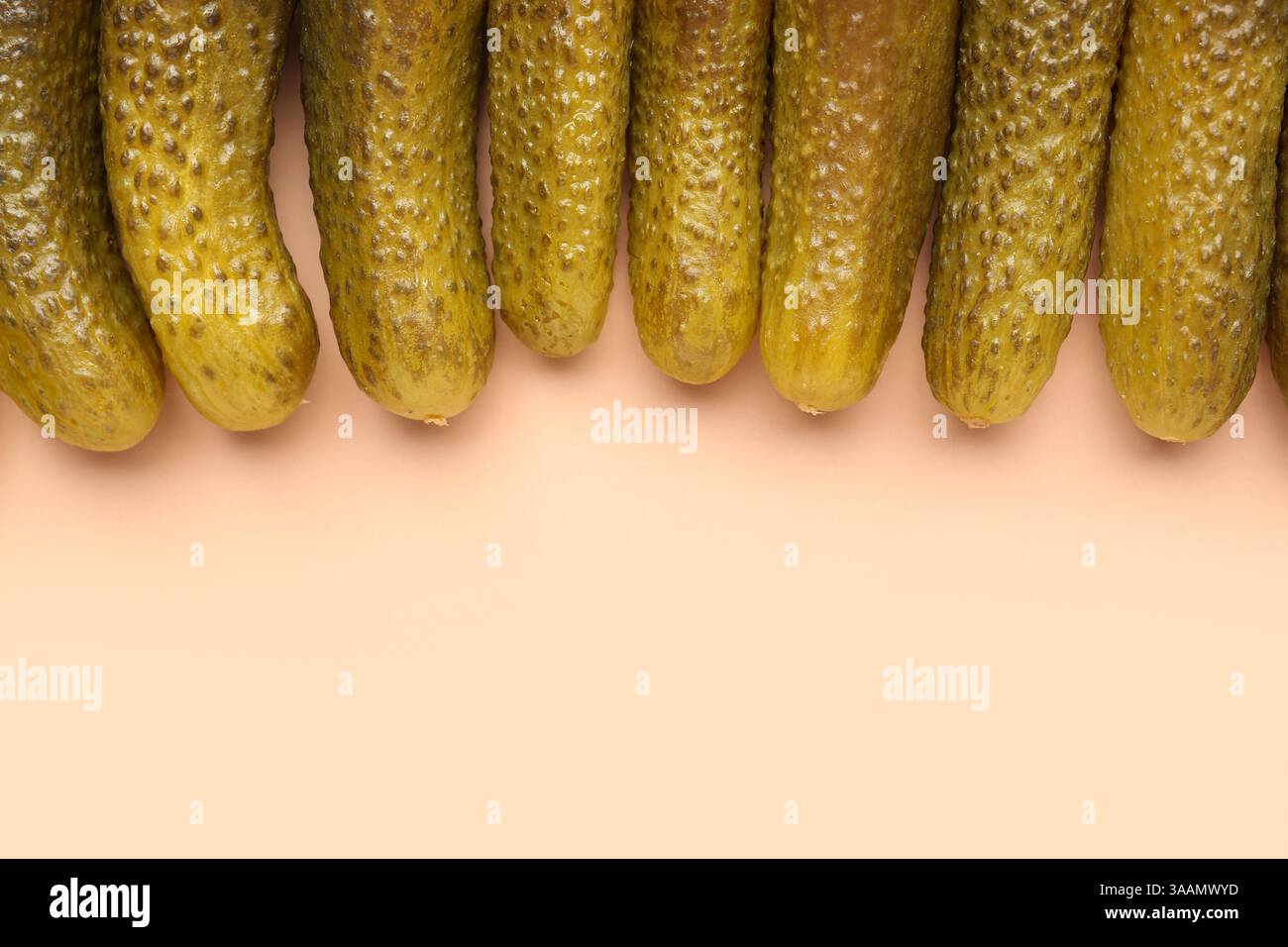 Pickled cucumbers on orange background Stock Photo