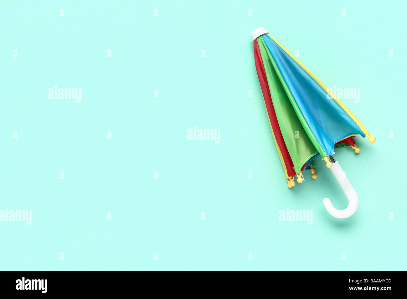Mini colorful umbrella on green background Stock Photo