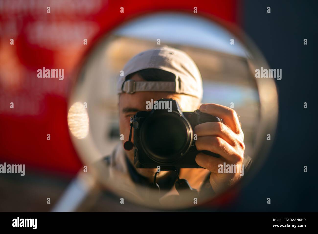 man with a camera reflection in a miror Stock Photo