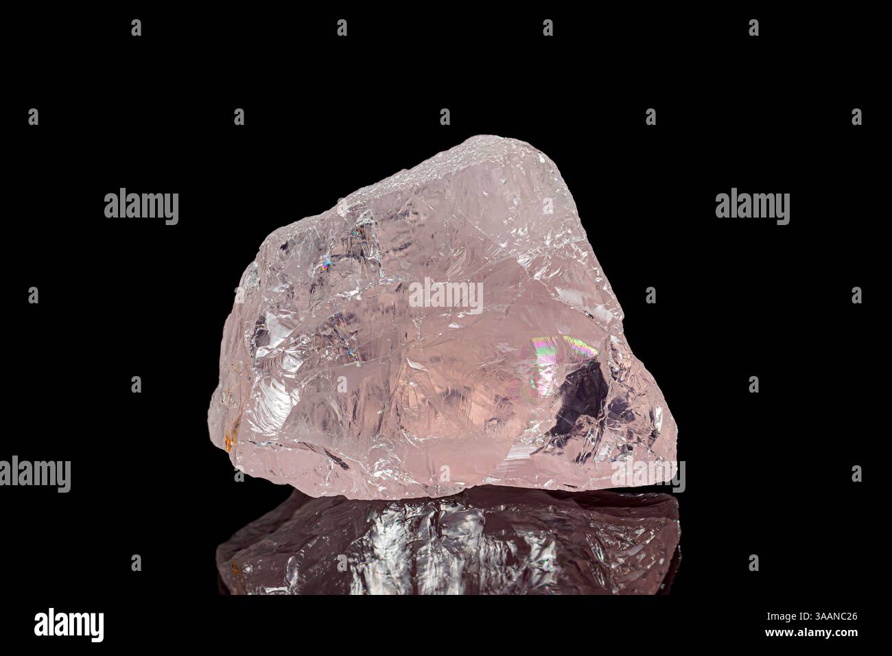 Natural rough rose quartz gemstone on dark background Stock Photo