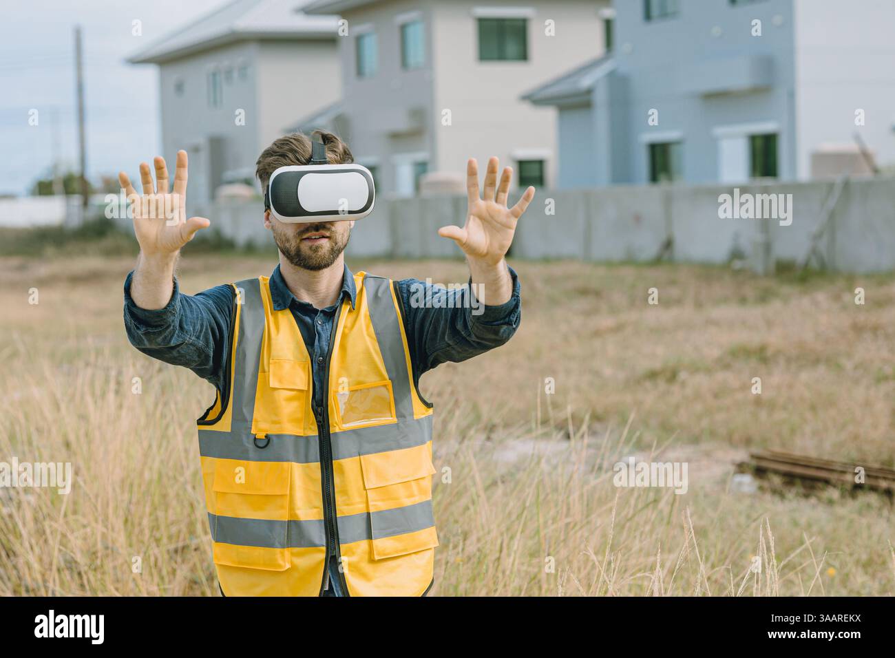 Engineer male worker using Visual reality VR or Augmented reality AR technology in construction industry. Modern digital innovation in engineering con Stock Photo
