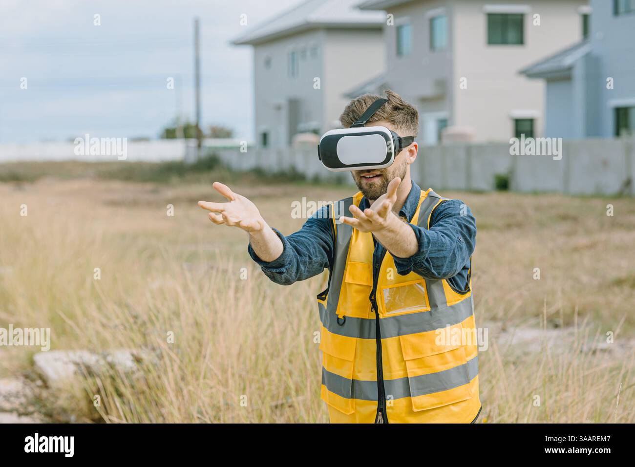 Engineer male worker using Visual reality VR or Augmented reality AR technology in construction industry. Modern digital innovation in engineering con Stock Photo