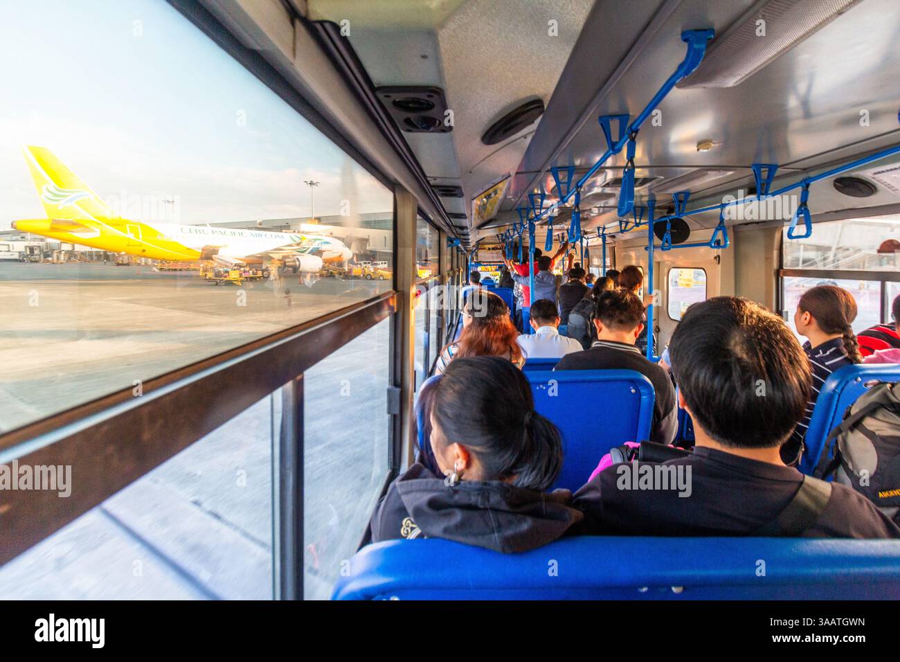 A busload of airline passengers heads to a waiting aircraft on the ...