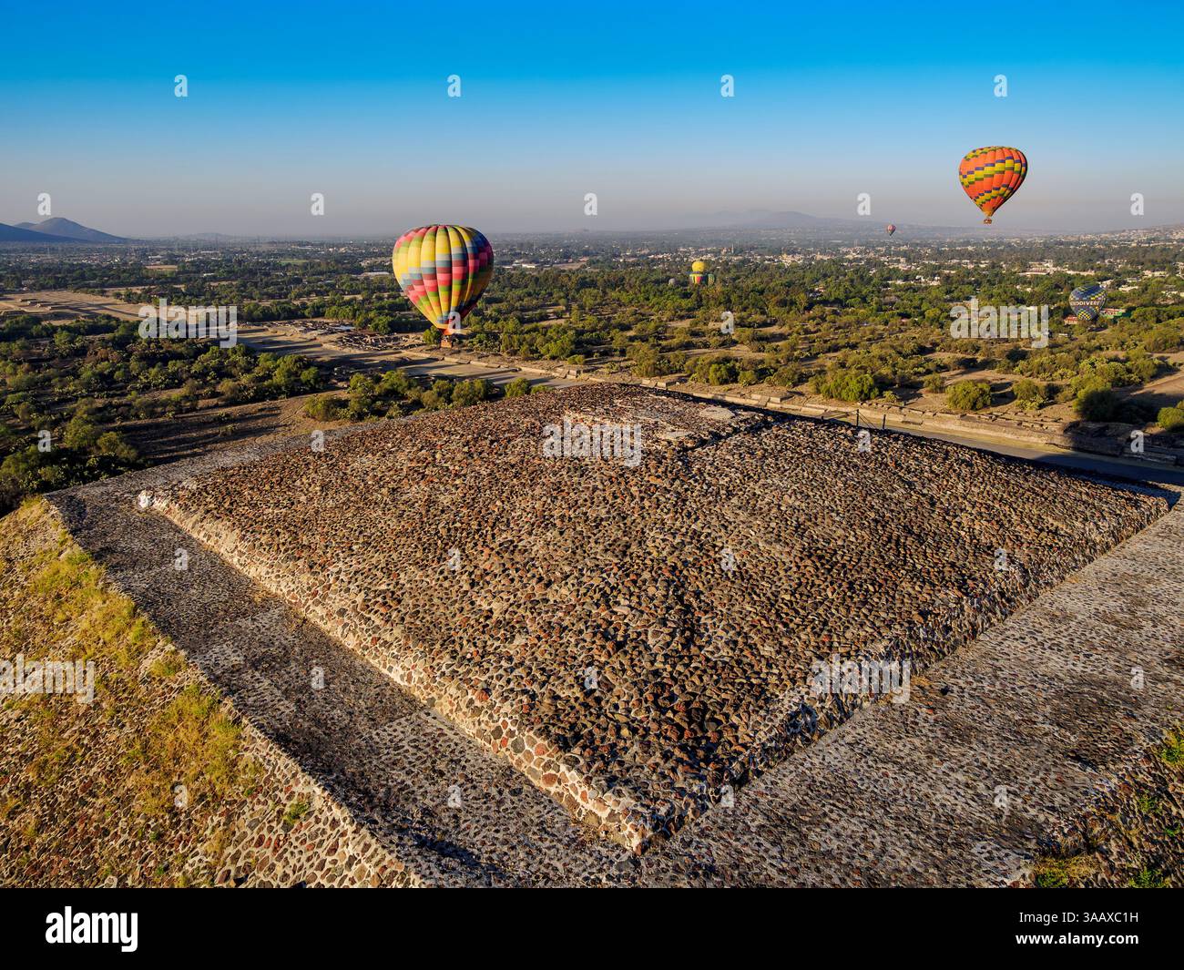 Hot air balloons flying over the Pyramid of the Sun at sunrise, aerial ...