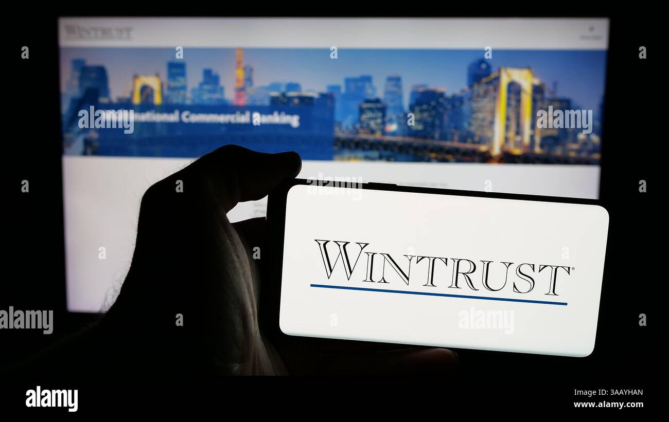 Wintrust In this photo illustration, a mobile phone with the logo of banking ...
