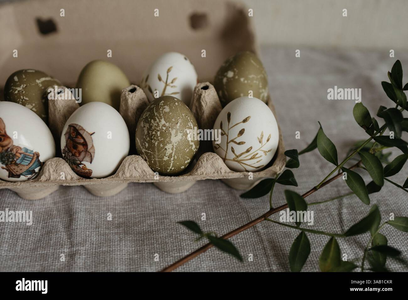Easter holiday. Painted olive-colored eggs on a linen tablecloth. Easter decoration. Stock Photo