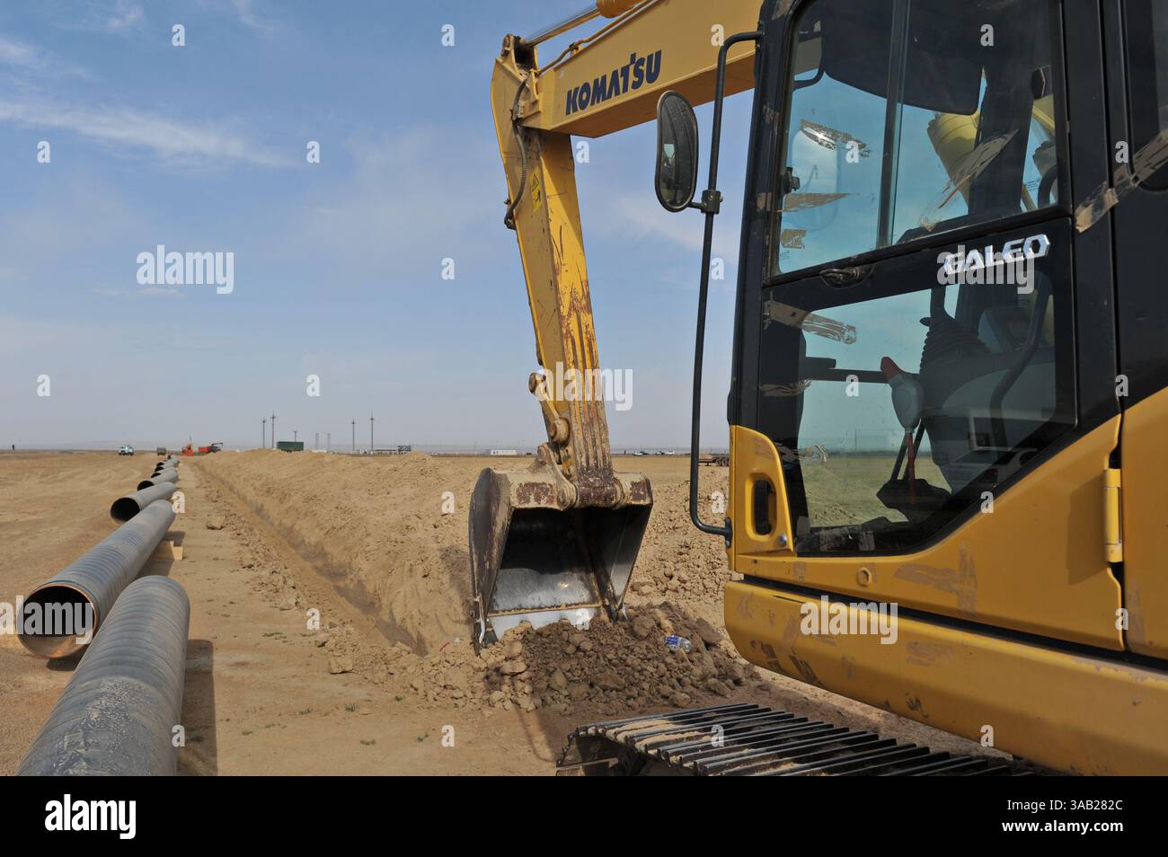 Excavator digs a trench for the construction of a gas pipeline Stock ...