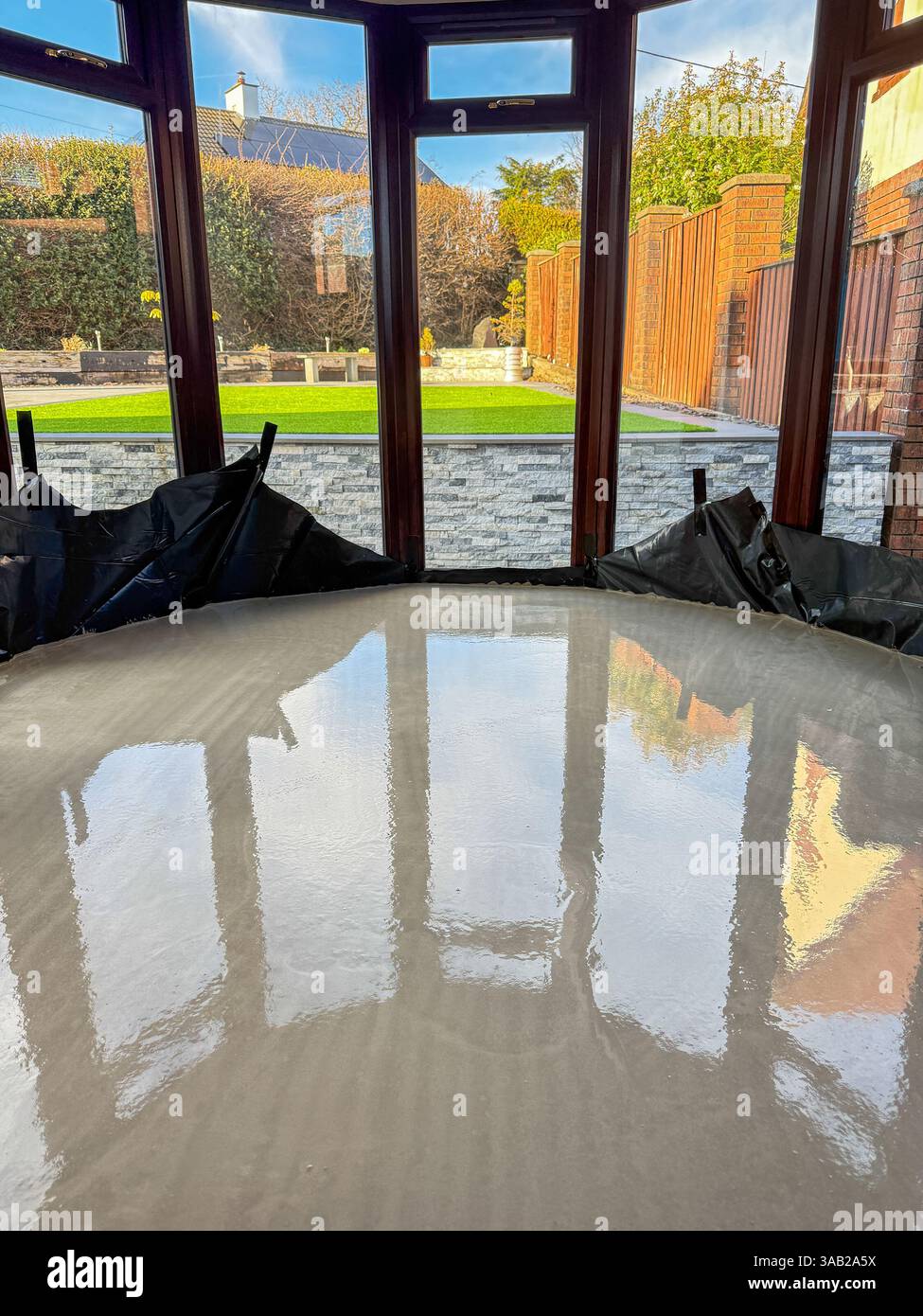 Newly laid wet concrete on the floor of a conservatory of a house. No people. - Smartphone Captured Stock Image