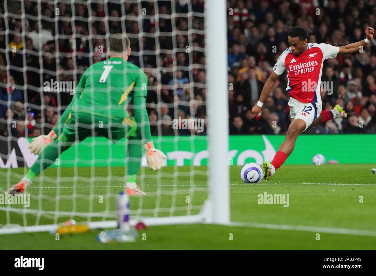 Arsenal's Jurrien Timber, right, kicks the ball during the English ...