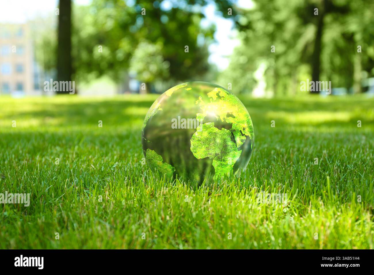Earth globe in glass ball on green grass outdoors. Concept of ...