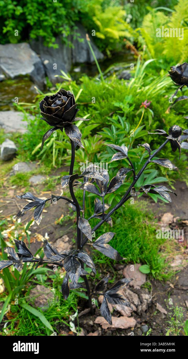 Forged metal roses in park by pond on embankment of Iset River ...