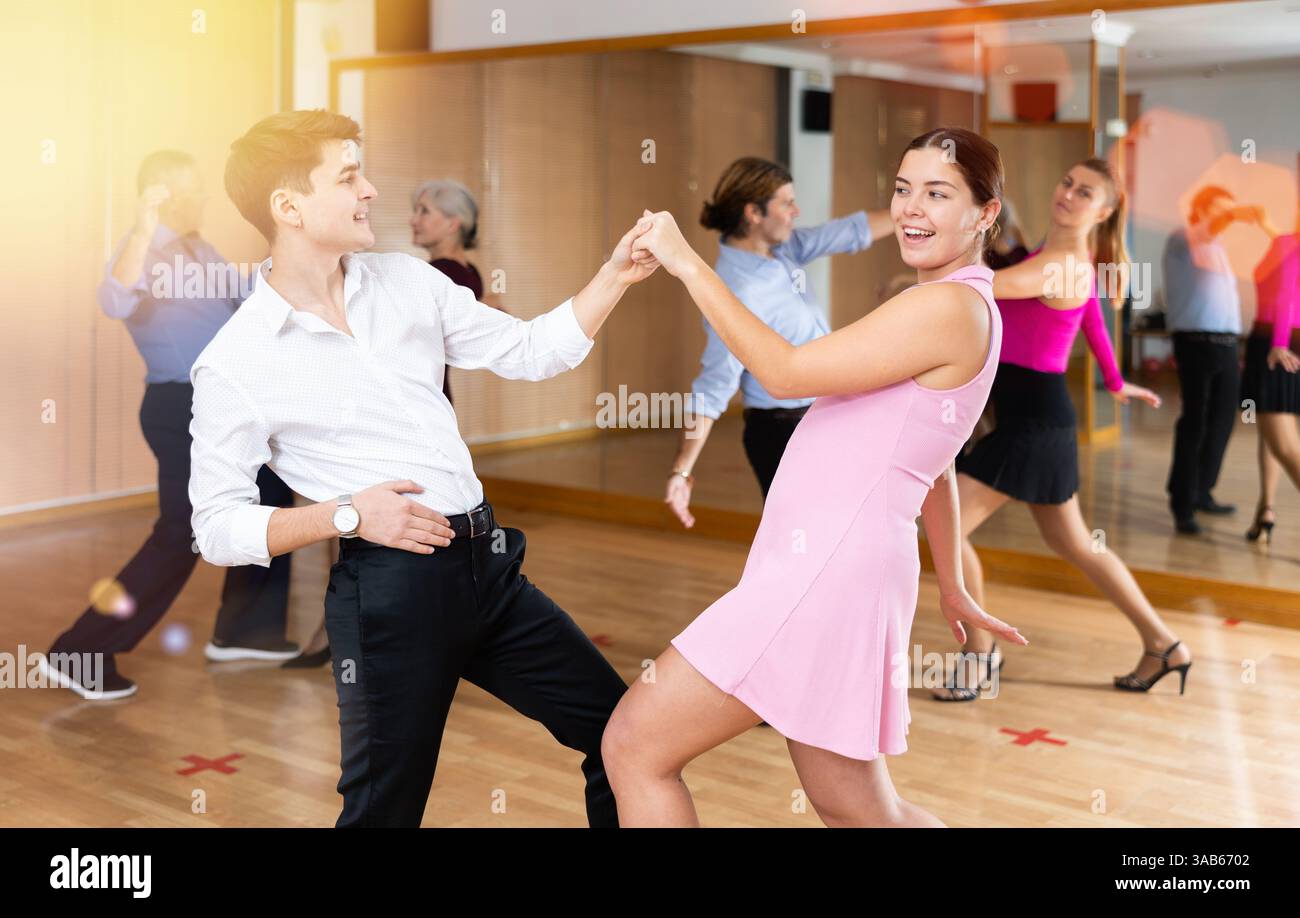 Young pair practicing Latino dance in dance studio Stock Photo