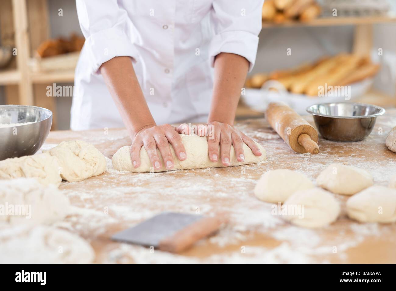 Chef working with dough in a bakery Stock Photo
