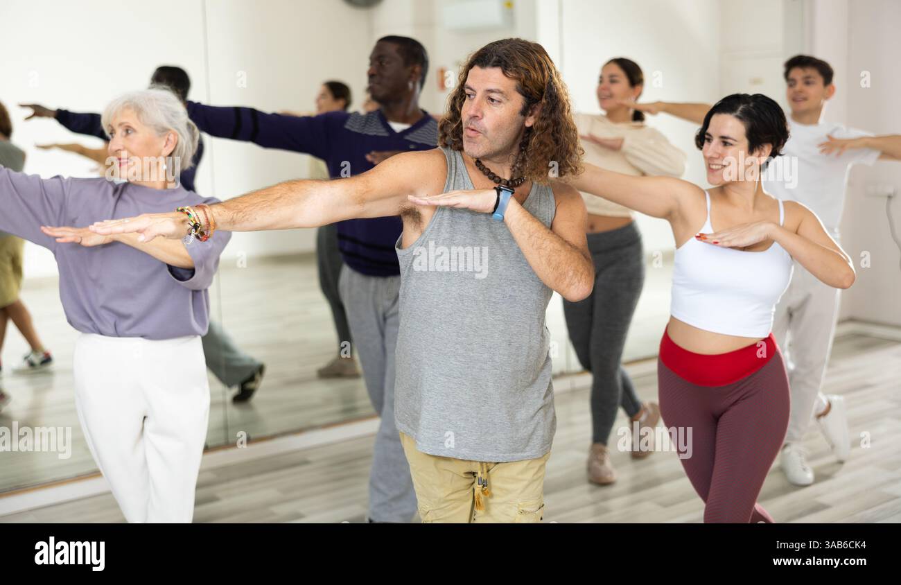 Emotional man learning dynamic dances in choreography class Stock Photo