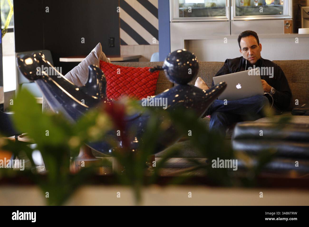 October 7, 2016 - San Diego, CA, USA - Russell Schneider, who owns a software company, works on his laptop in the third floor common area of WeWork. Co-working operators such as Regus and WeWork specialize in creating unique work environments for millennials who want flexible office spaces. (Credit Image: © John Gibbins/TNS via ZUMA Wire) Stock Photo