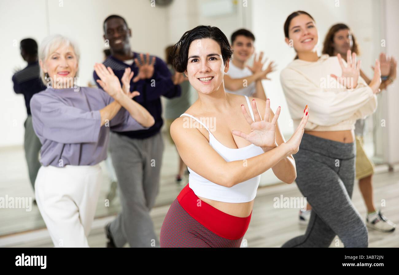 Young Hispanic woman practicing vigorous dance movements Stock Photo
