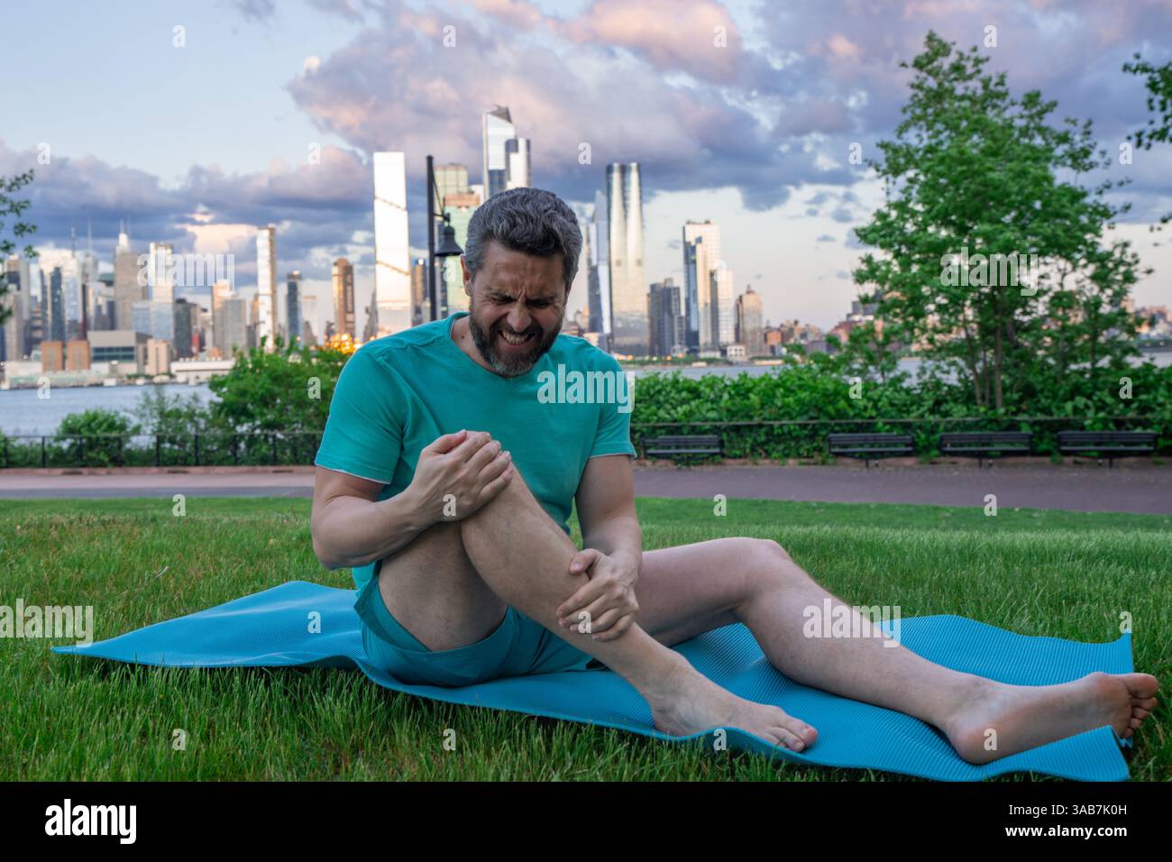 Knee after sport. Man struggling with leg pain. Injured man holding ...