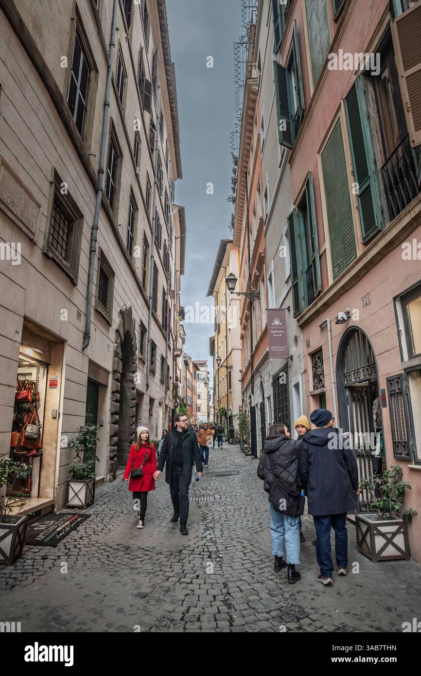 Cobblestone Walk Rome ROME, ITALY - JANUARY 15, 2025: Tourists and locals walking along a ...