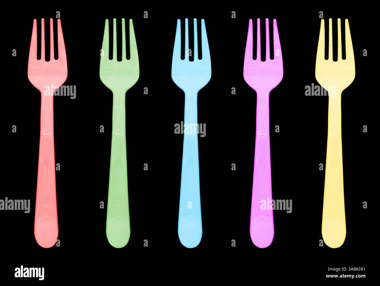 Multi color plastic fork isolated on black background. Disposable tableware set isolated Stock Photo