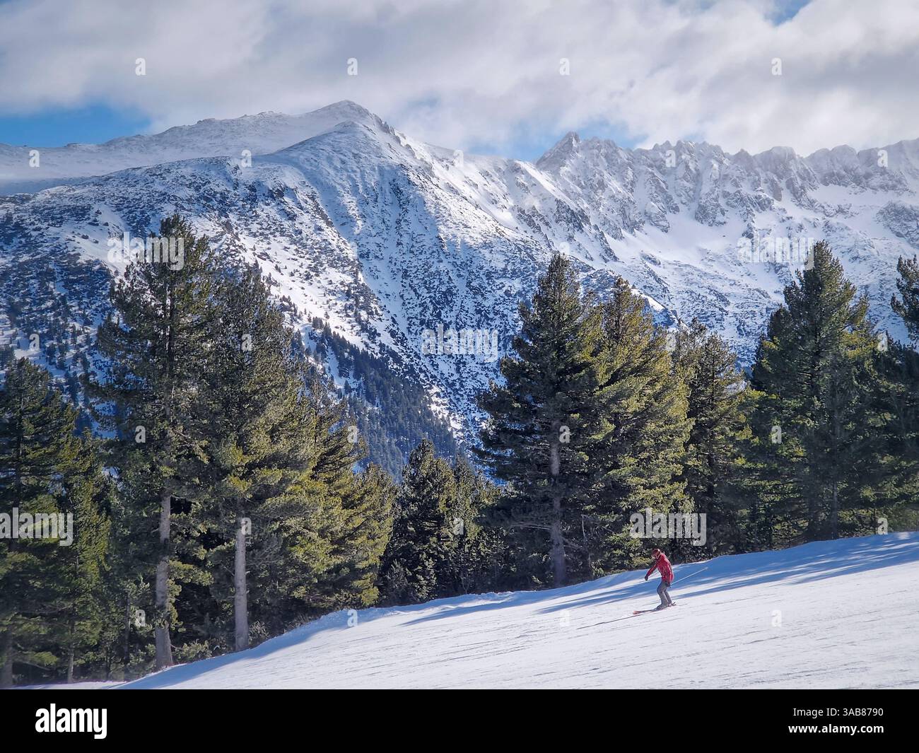 View to the snowy slope with a freeride skier having fun at Bansko ski resort in Bulgaria - Smartphone Captured Stock Image