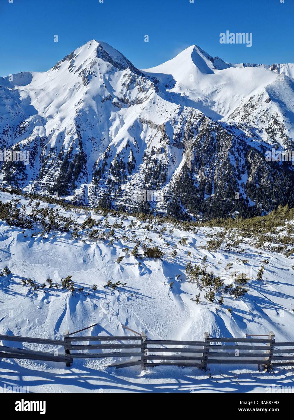 Aerial view above the Pirin mountains ridge covered with snow. Winter scene at Bansko ski resort in Bulgaria - Smartphone Captured Stock Image