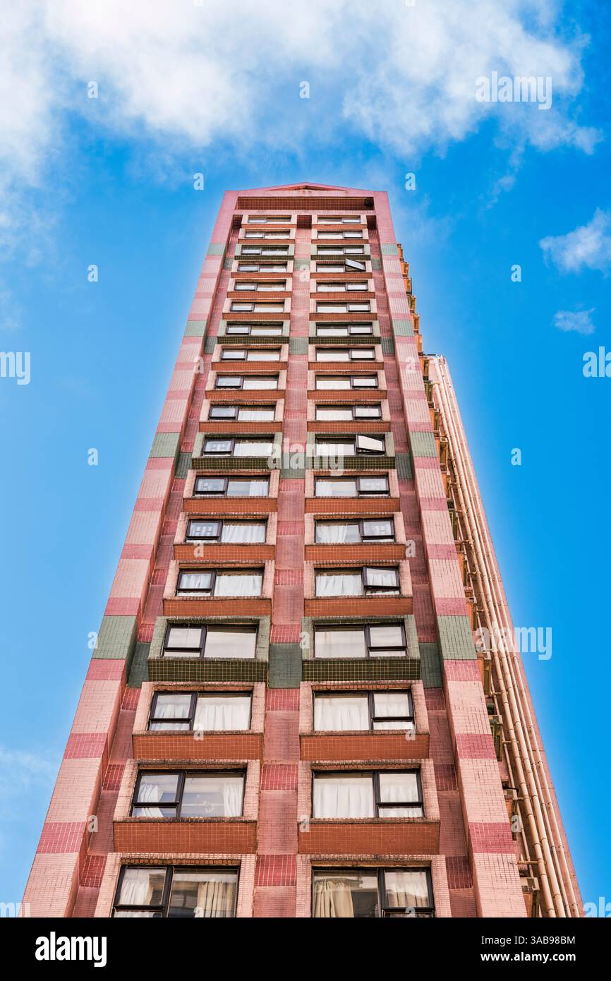 From below a tall residential building in Hong Kong, highlighted by a ...