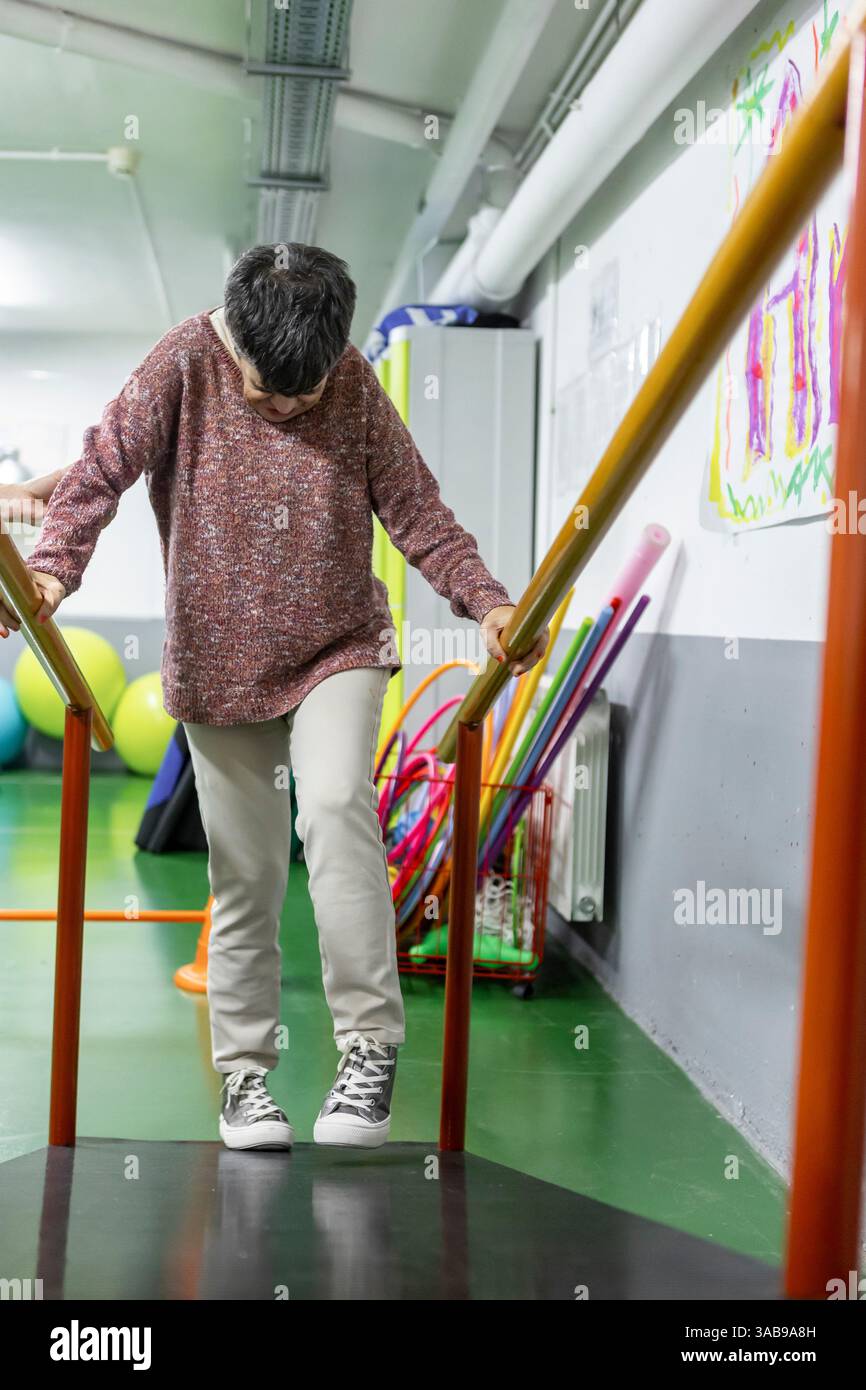 Woman Using Handrail Woman walks inside residence hi-res stock photography and images - Alamy
