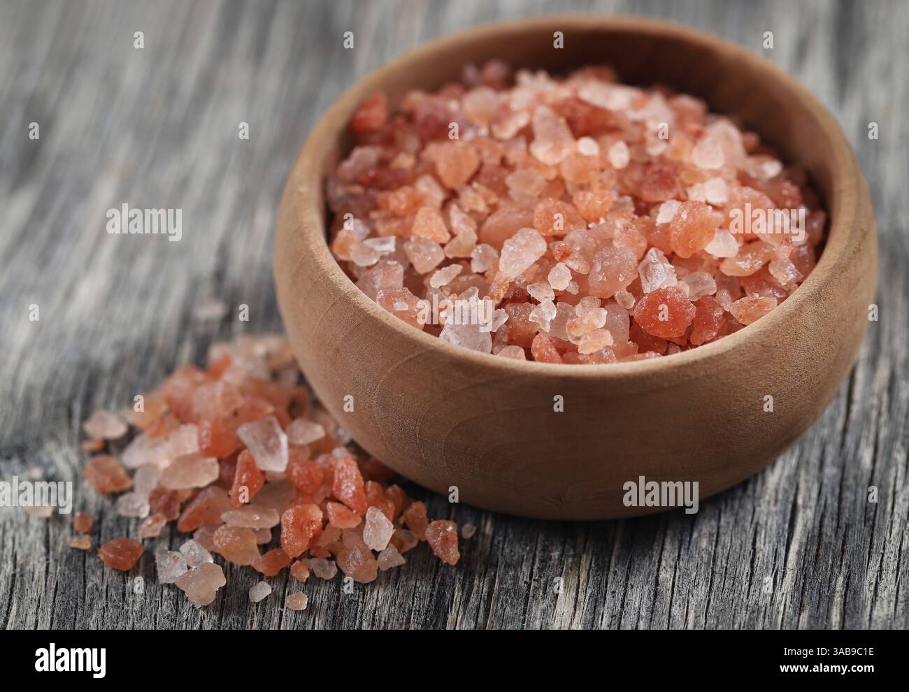 Himalayan pink salt  on wooden surface Stock Photo