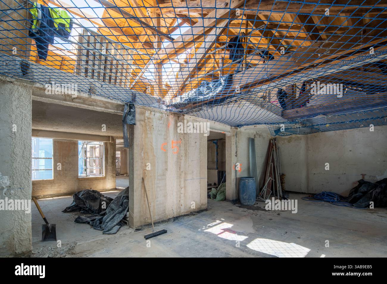 Netting Centres Process Interior view of a building under construction. Tools, safety netting ...