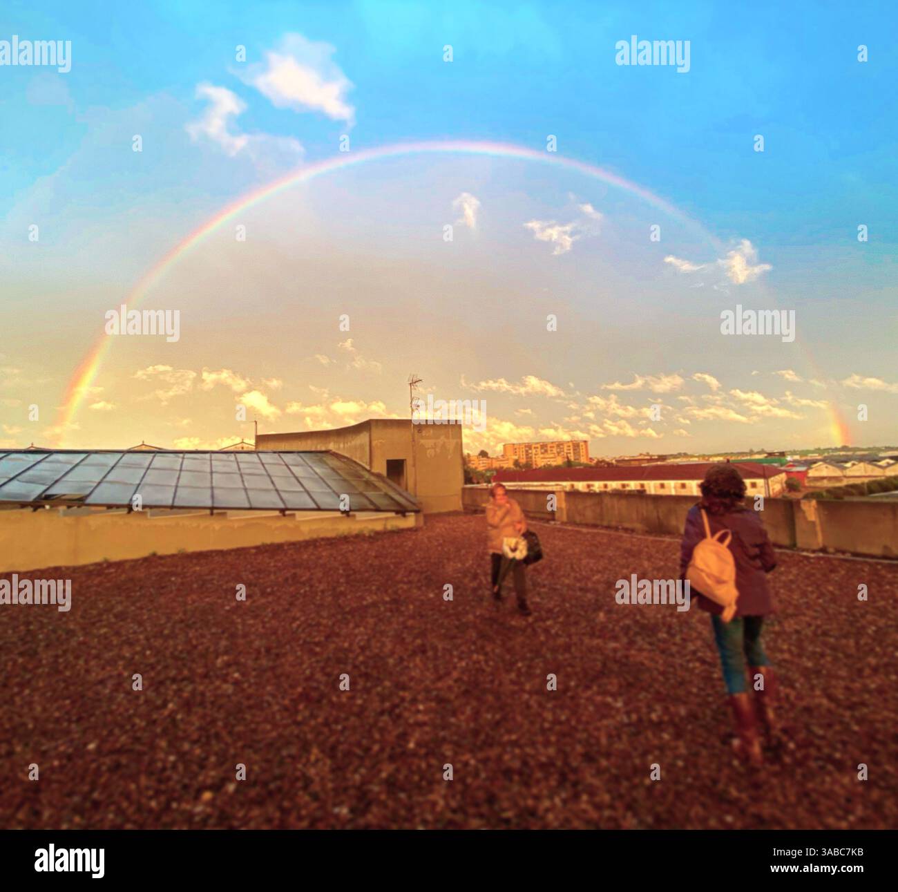People watch a full arco iris in Jerez de la Frontera, Cadiz, Andalucia, Spain - Smartphone Captured Stock Image
