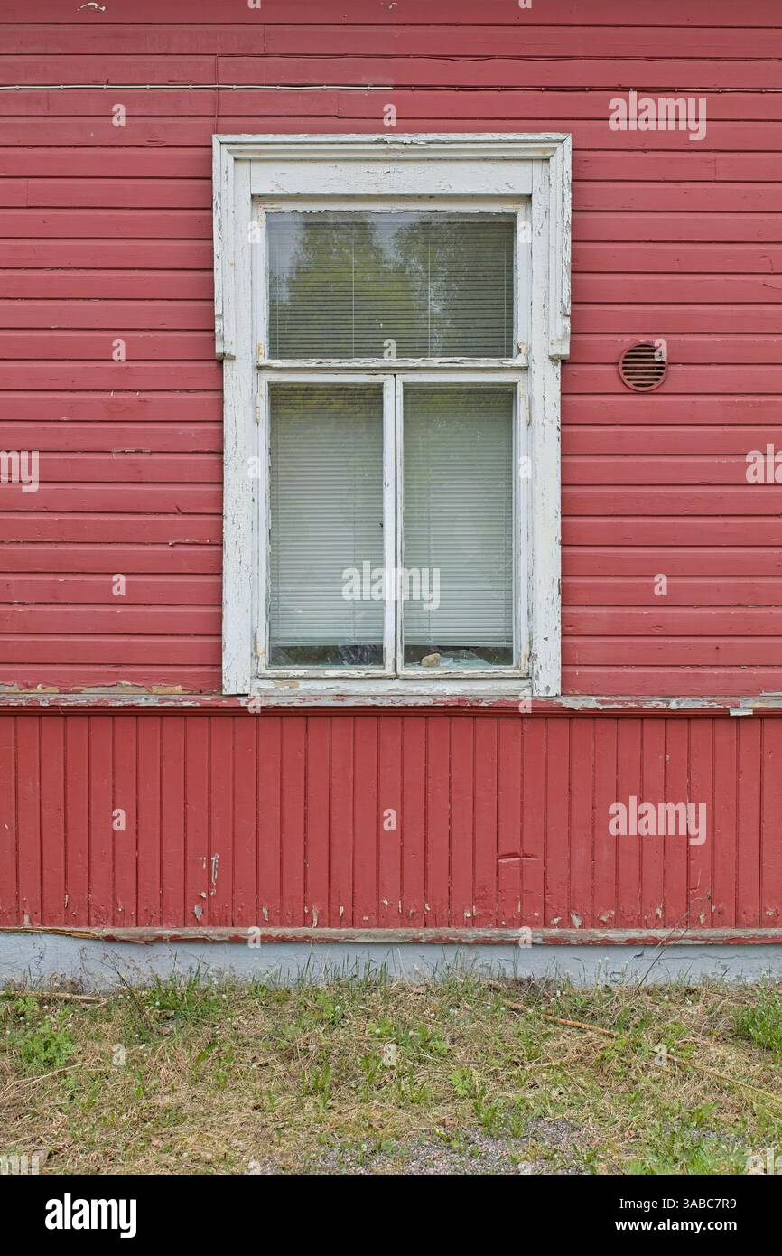 Old white framed window on red painted wooden wall. Stock Photo