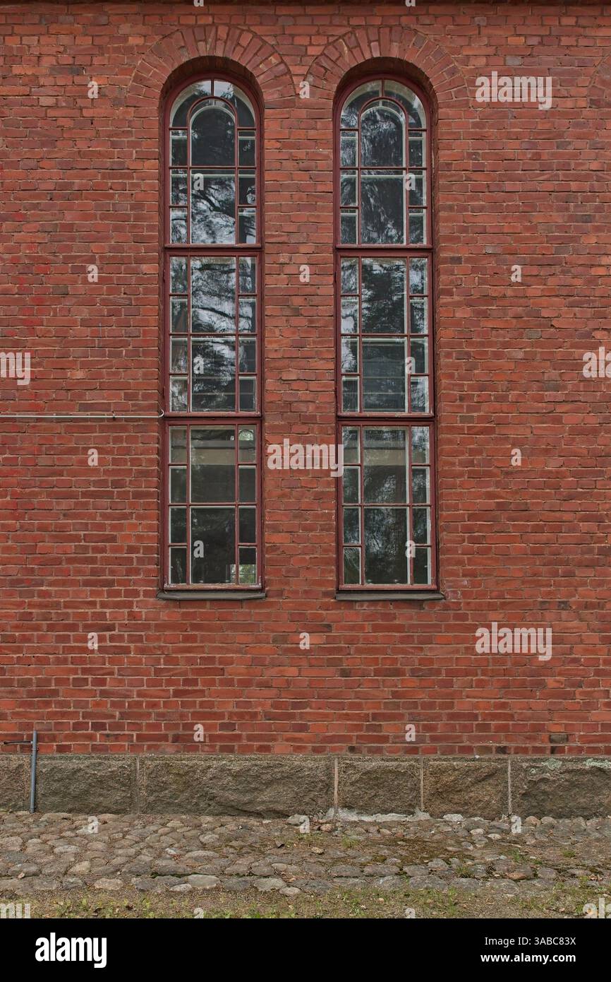 Old brown framed windows with arch on red brick wall Stock Photo - Alamy