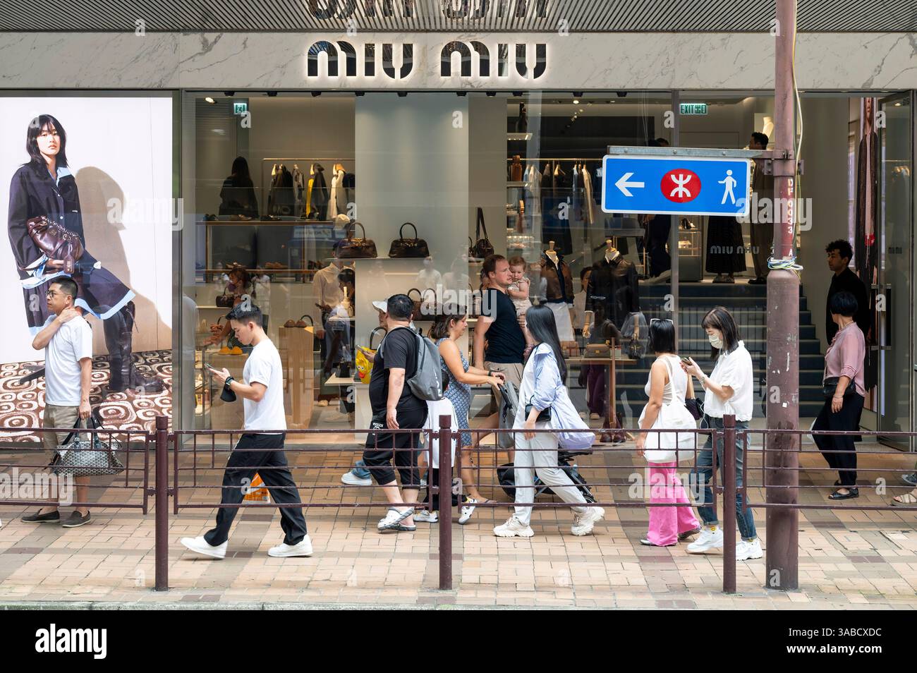 Pedestrians walk past a closed Italian high fashion women's
