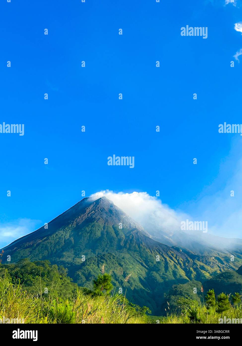 beautiful view of mount merapi against blue sky and white cloud - Smartphone Captured Stock Image