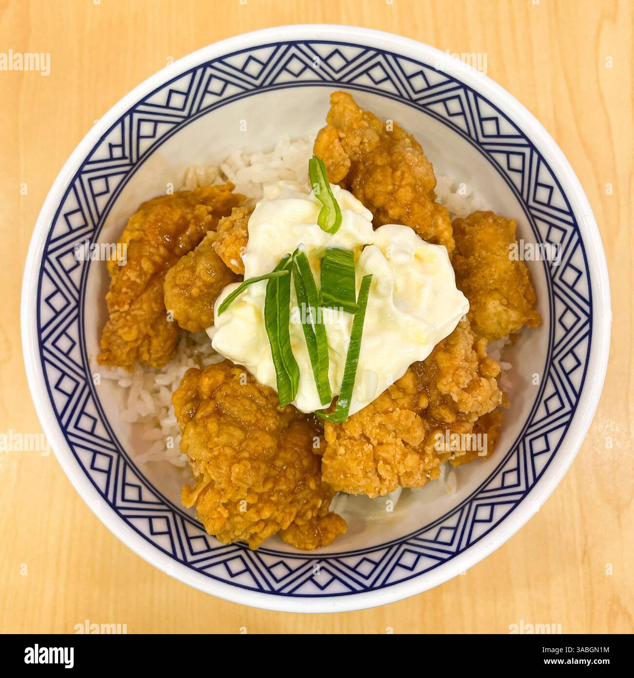 top view of rice bowl with crispy chicken bites and egg - Smartphone Captured Stock Image
