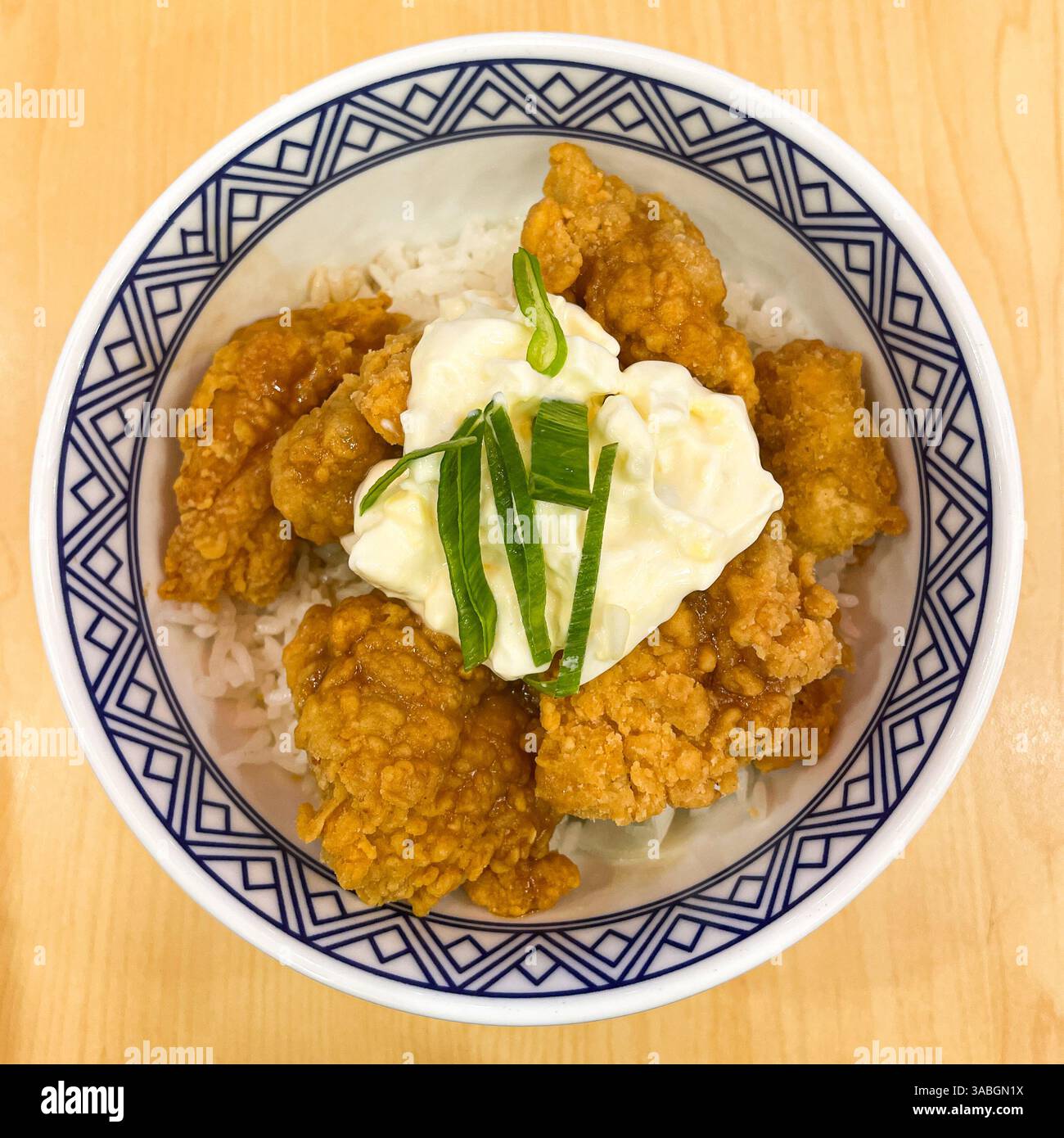 top view of rice bowl with crispy chicken bites and egg - Smartphone Captured Stock Image