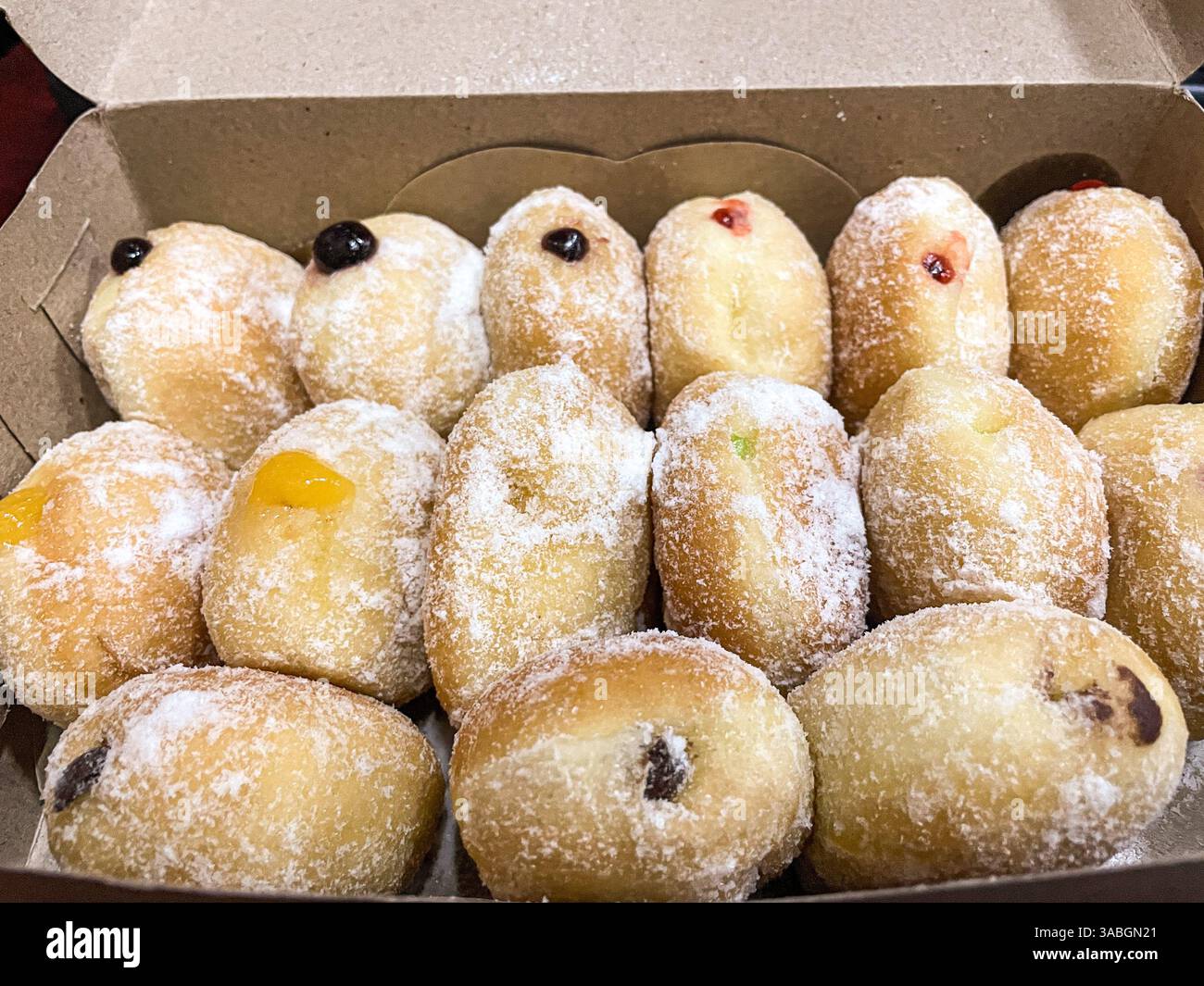close up view of box full of bomboloni doughnut - Smartphone Captured Stock Image