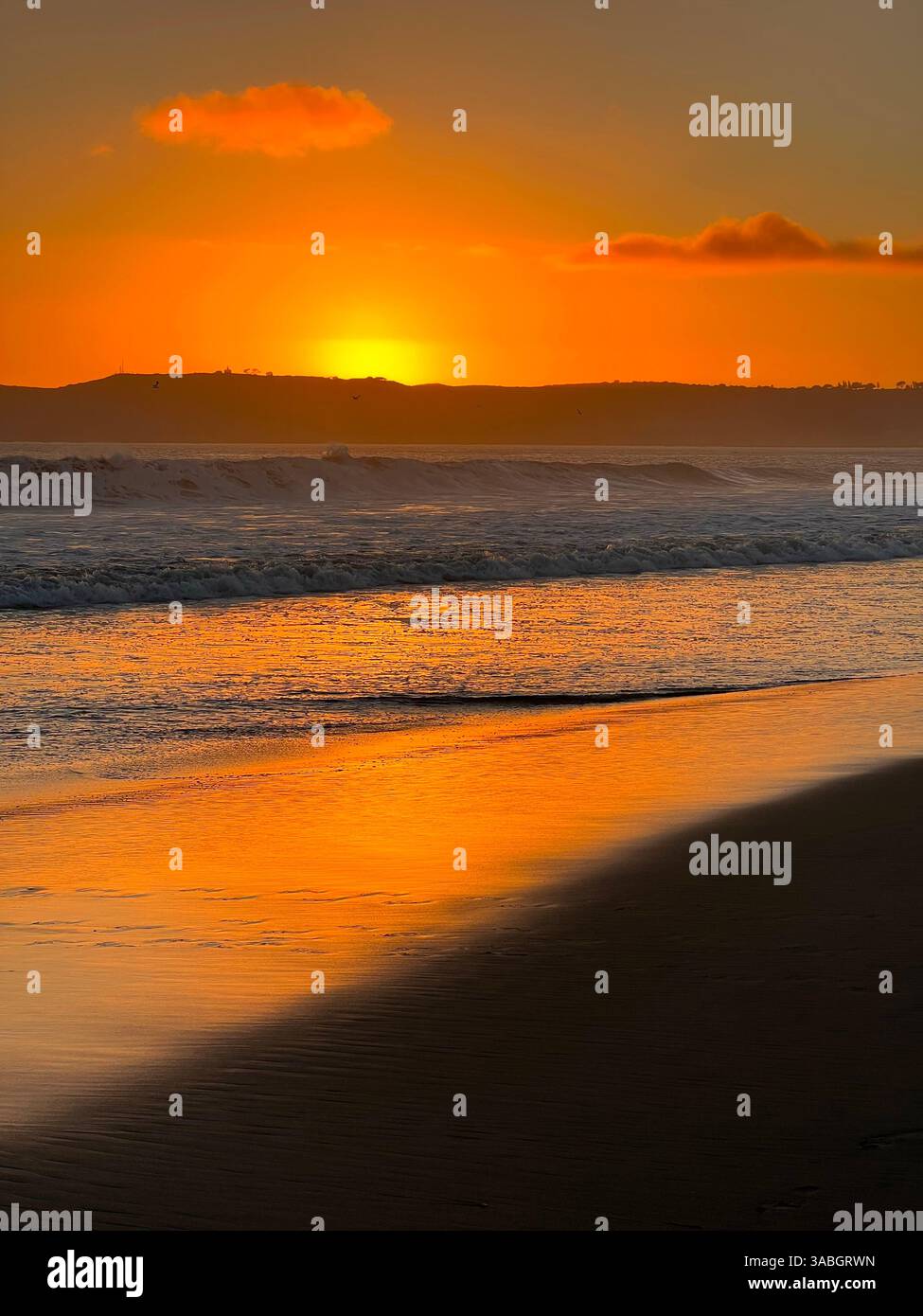 Stunning coastal ocean sunset with vibrant colors reflecting off the water, creating a peaceful and serene atmosphere. - Smartphone Captured Stock Image