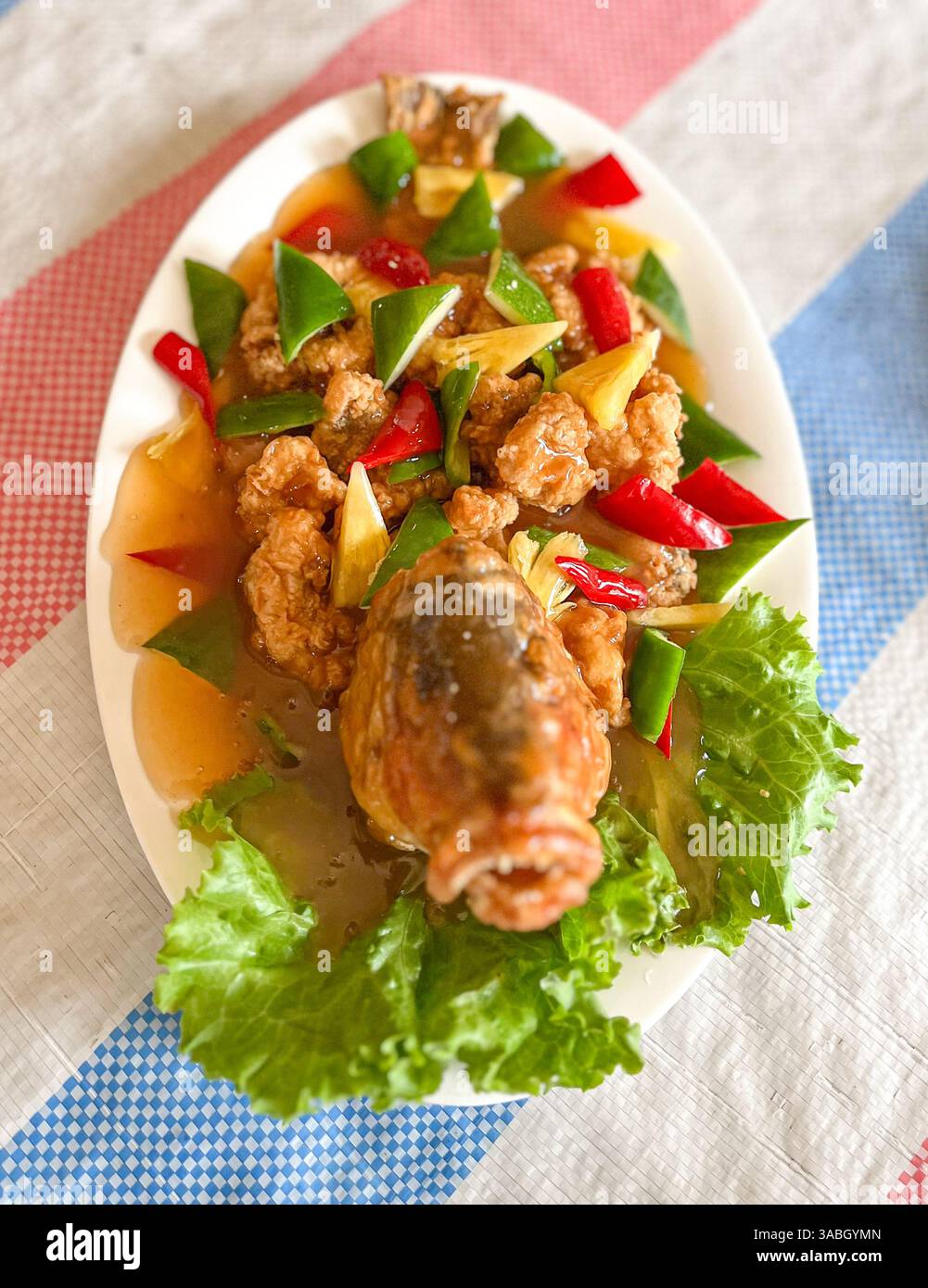 deep fried crispy whole fish with vegetables in sweet and sour sauce - Smartphone Captured Stock Image