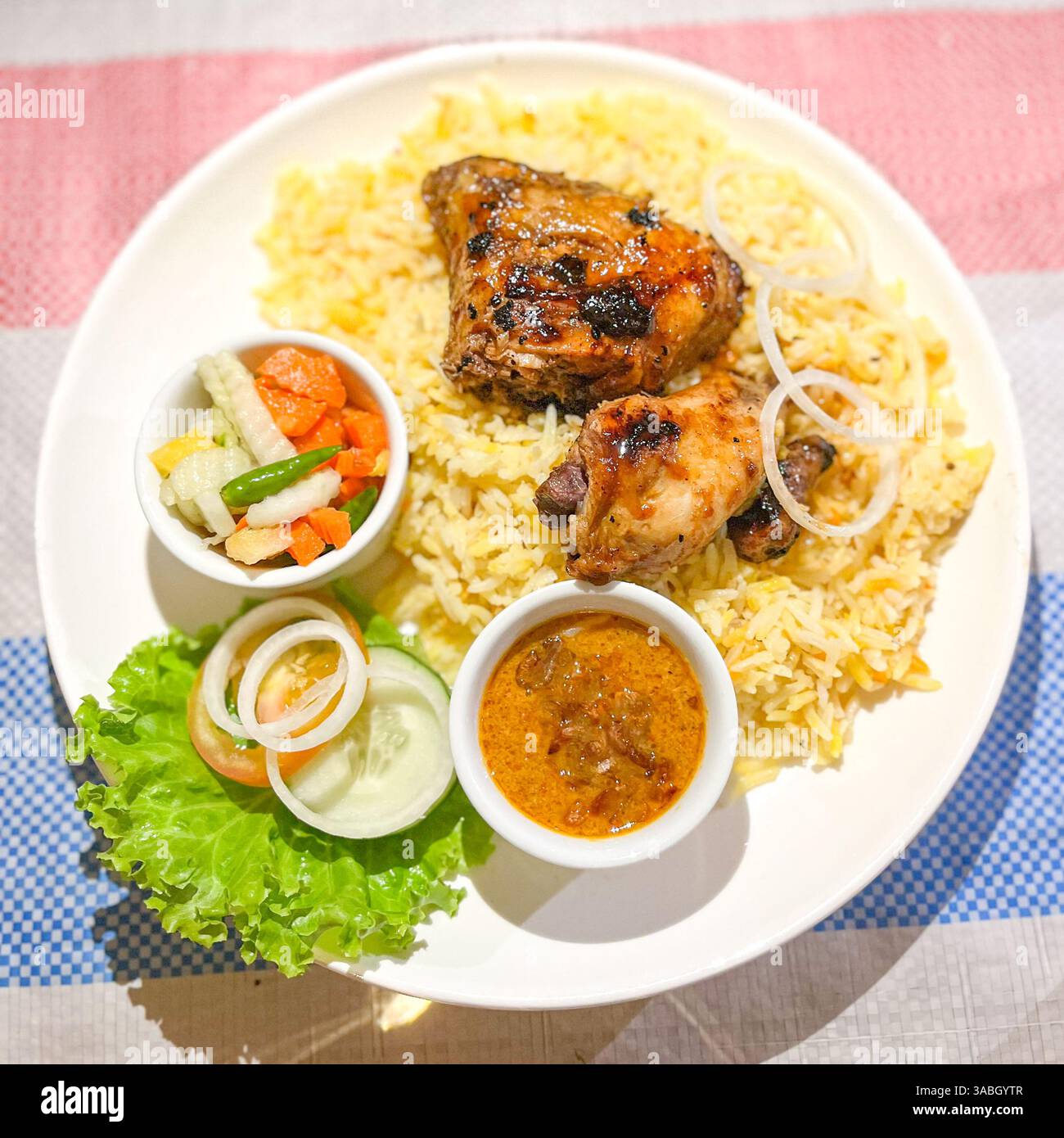 Top View of Biryani rice served with delicious meat , pickles and curry - Smartphone Captured Stock Image