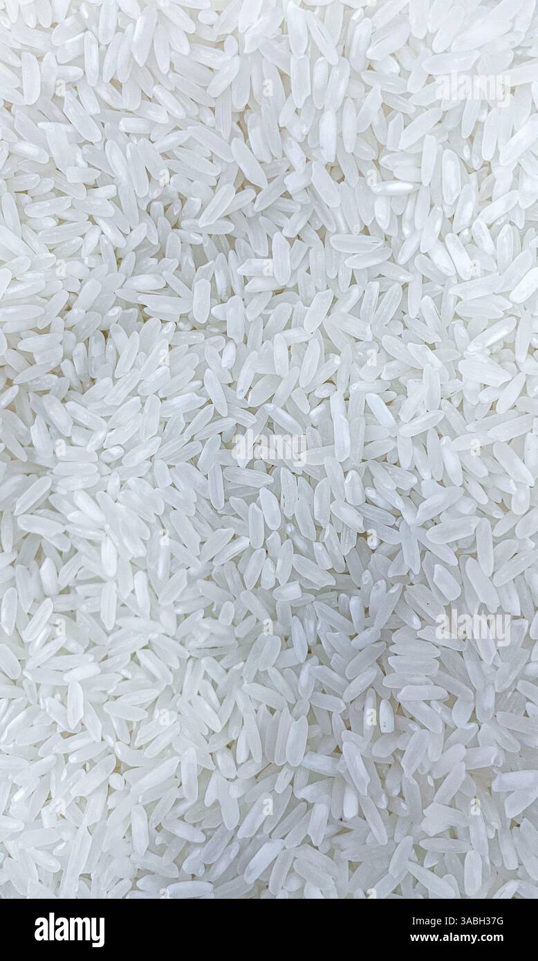 top view uncooked white rice seeds as food texture background - Smartphone Captured Stock Image