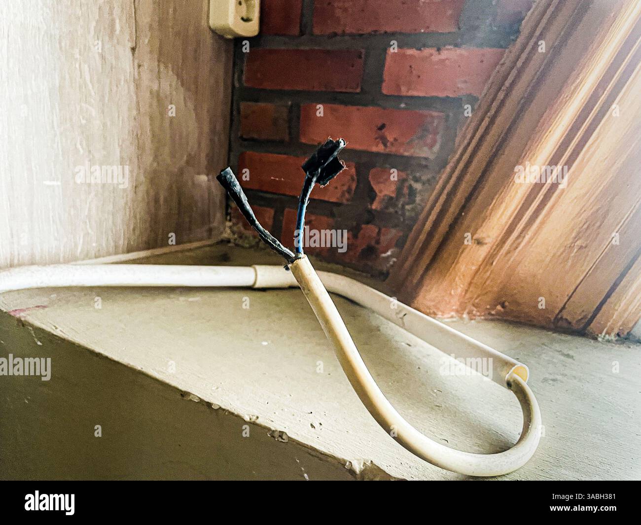 The exposed end of the electrical cable was damaged and only covered with duct tape - Smartphone Captured Stock Image