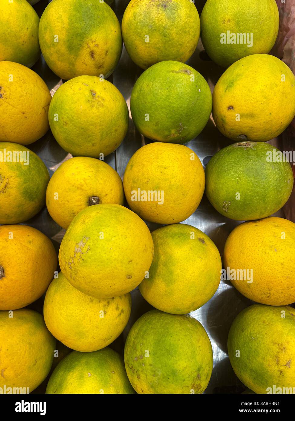 fresh tangerine with green skin on fruit market - Smartphone Captured Stock Image