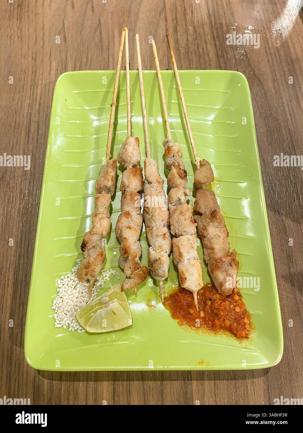 Sate Taichan, chiken satay grilled and served without peanut seasoning, top view - Smartphone Captured Stock Image