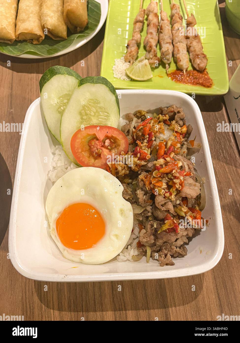 rice bowl, grilled beef belly with spices, served with rice and sunny side up egg. - Smartphone Captured Stock Image