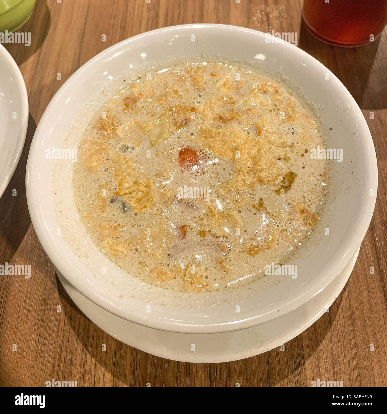 Soto Betawi. Traditional beef and offal soup from Betawi, Jakarta. served on bowl , Top View - Smartphone Captured Stock Image
