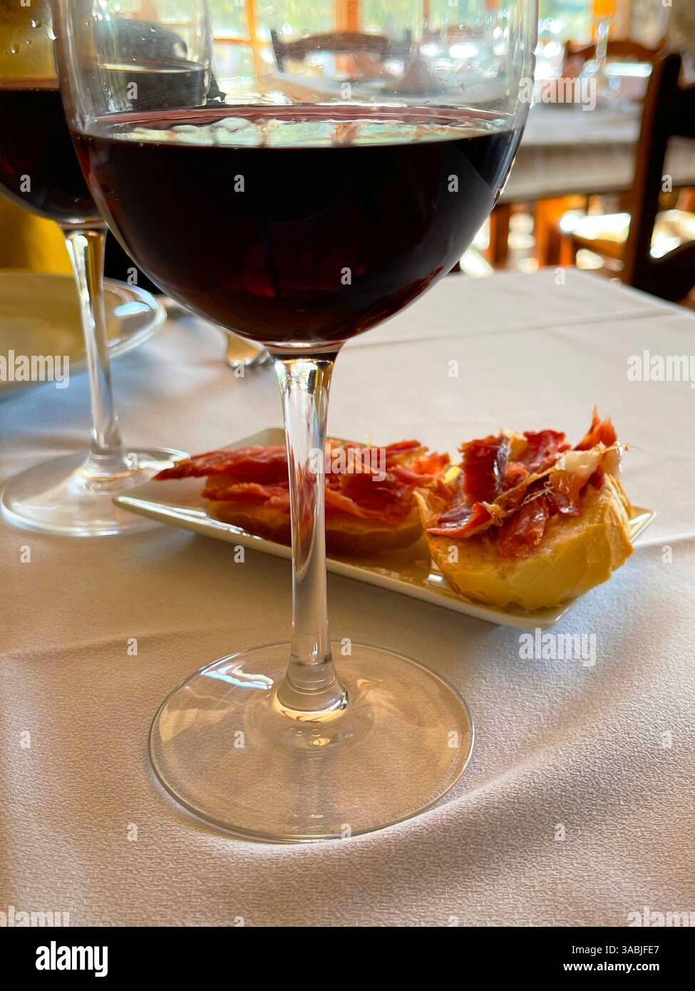 Glasses of red wine with tapa. Spain. - Smartphone Captured Stock Image