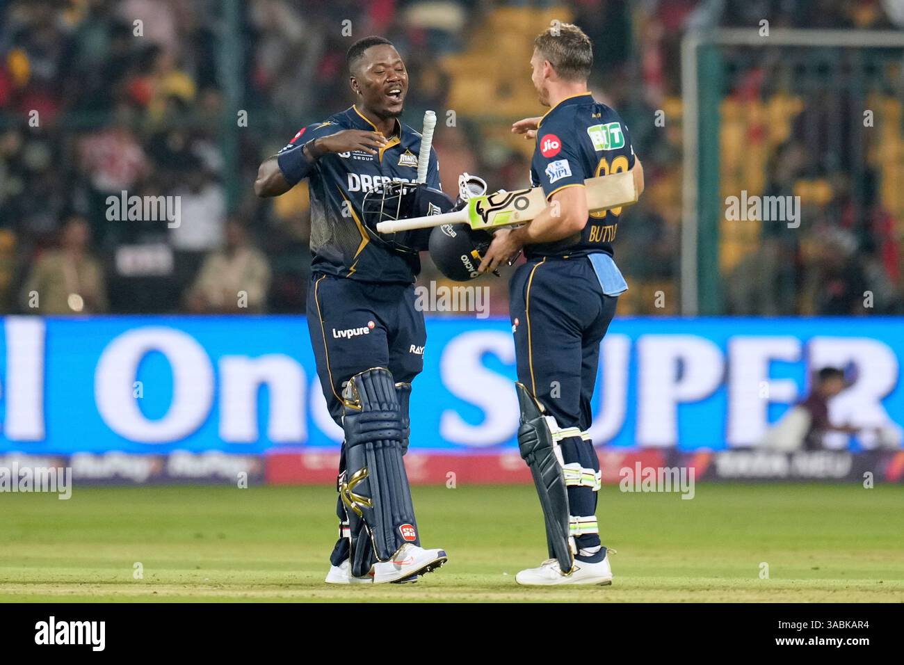 Gujarat Titans' Sherfane Rutherford, left, walks toward batting partner ...