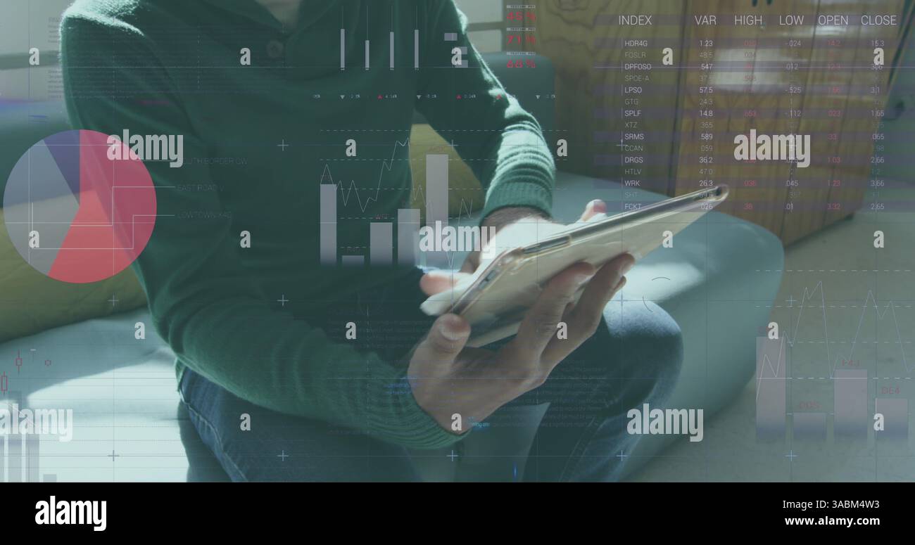 Statistical data processing against man using digital tablet at office Stock Photo