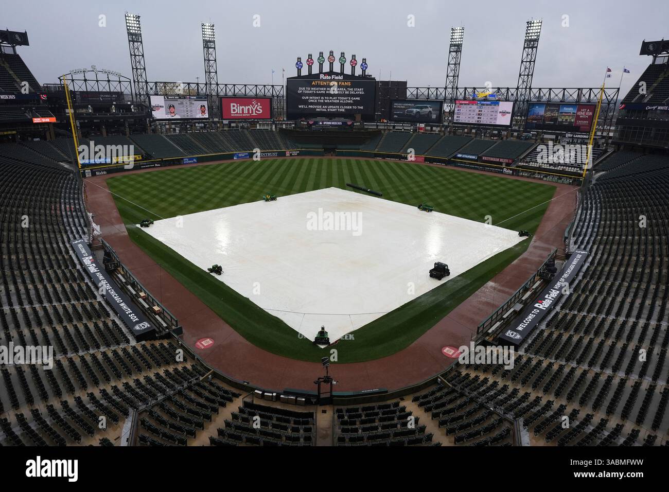 A tarp covers the infield during a rain delay before a baseball game ...